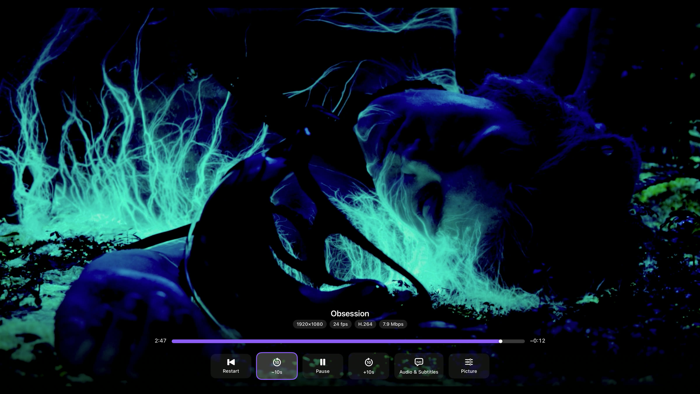Rivue on Apple TV — movie playing with transport bar, stream chips and measured bitrate